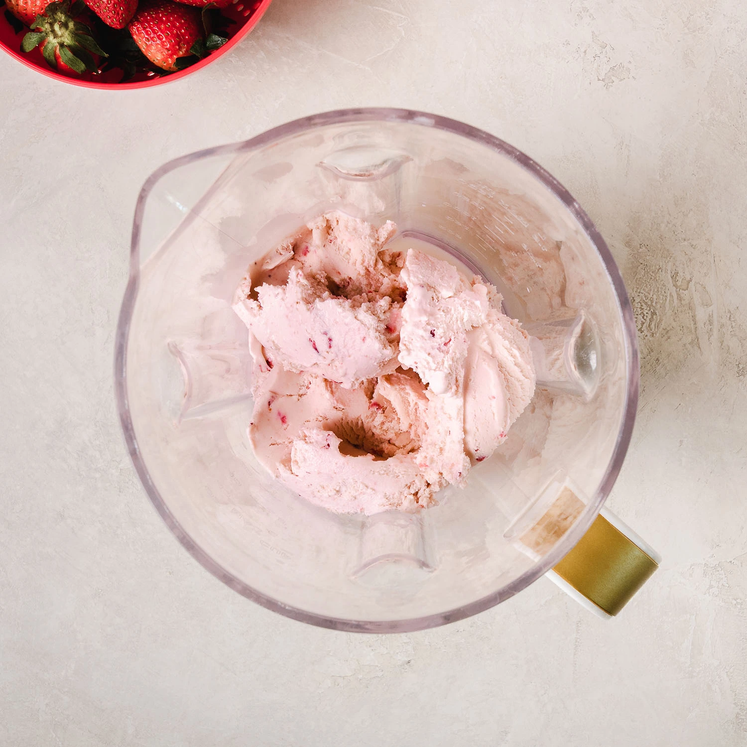 3 scoops of strawberry icecream and 1 cup of milk in a blender.