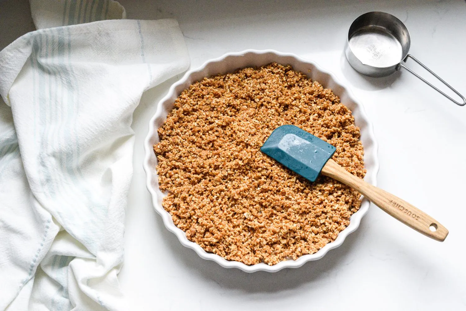 Granola mixture in a 9 inch tart pan.