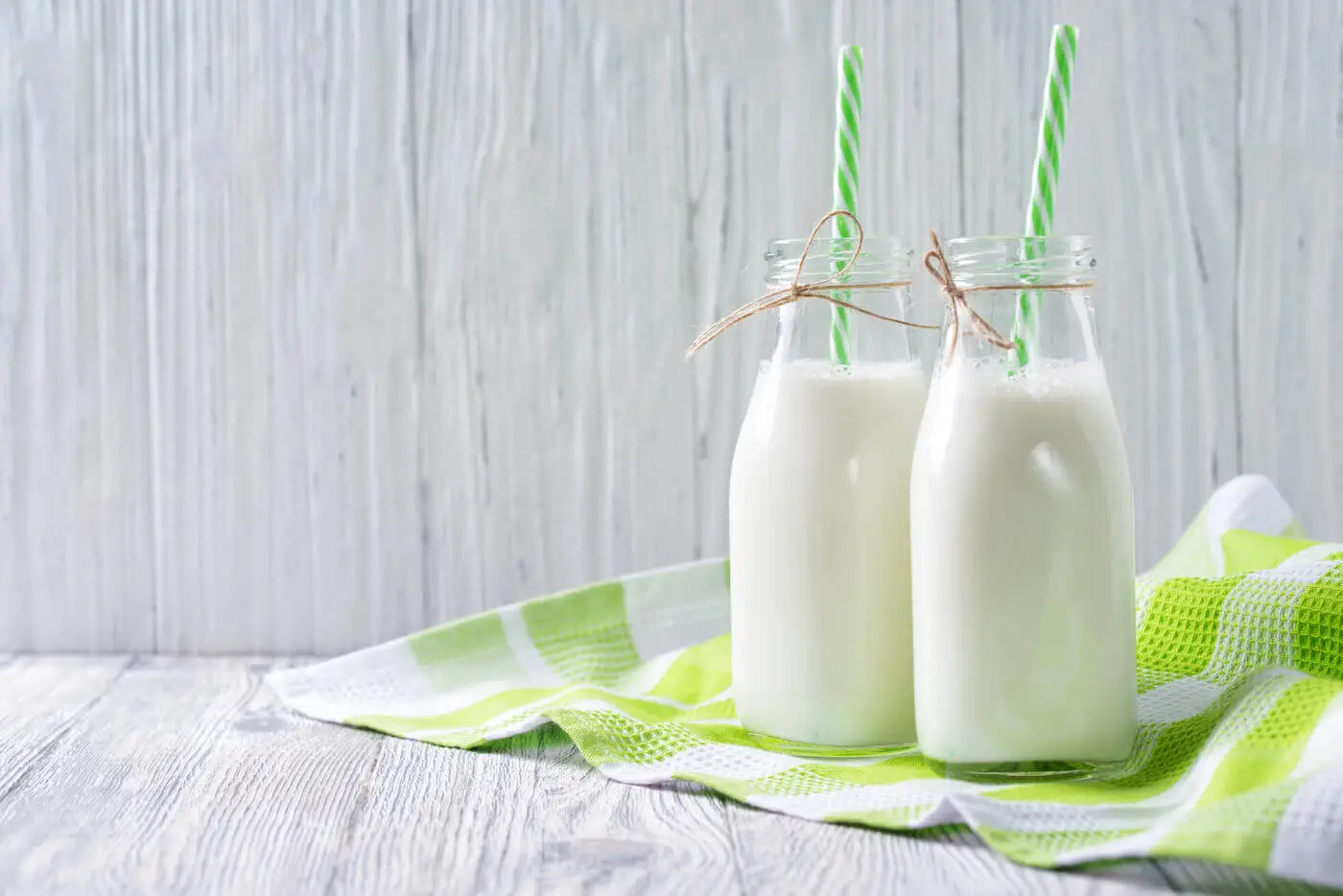 Two bottles of milk with straws