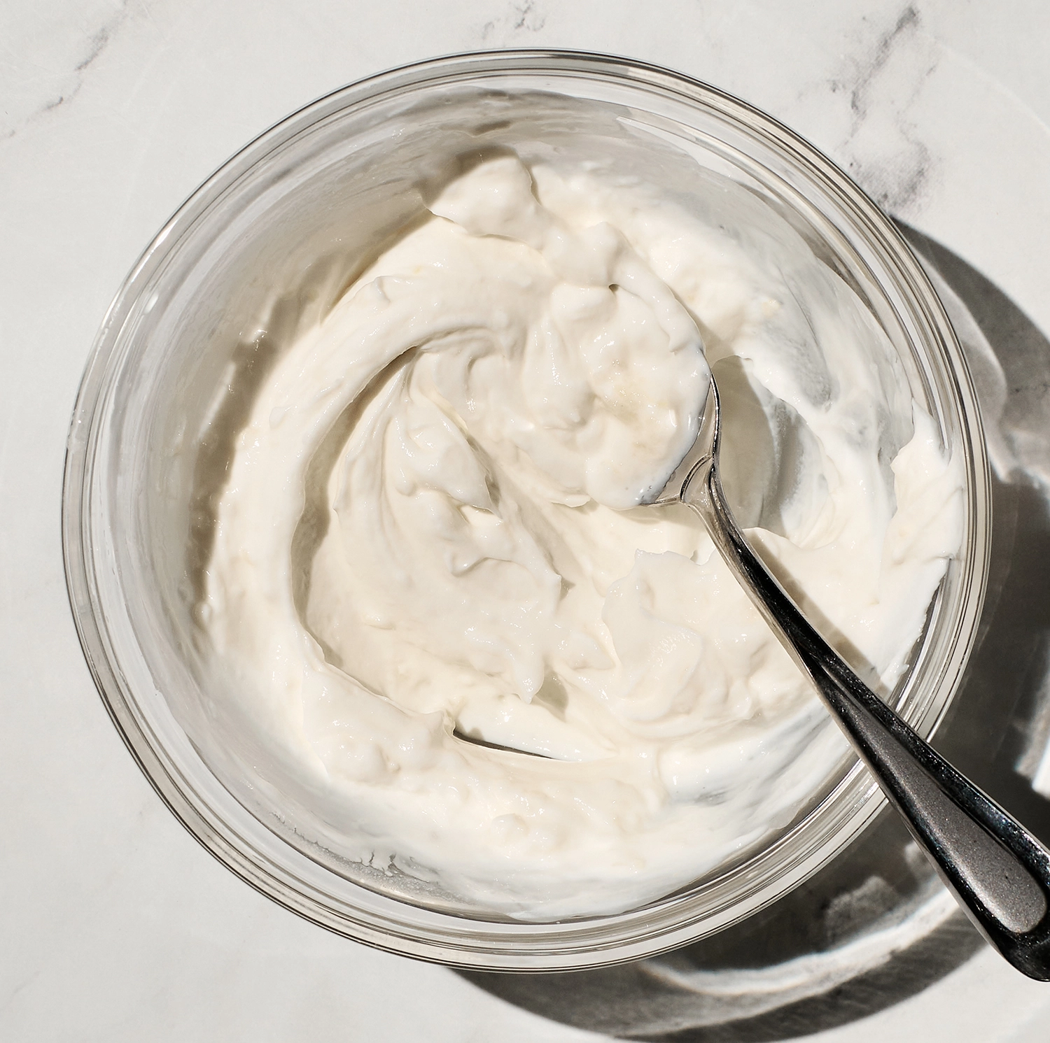 Greek yogurt, minced garlic, lemon juice, and flakey salt mixed in a small bowl.