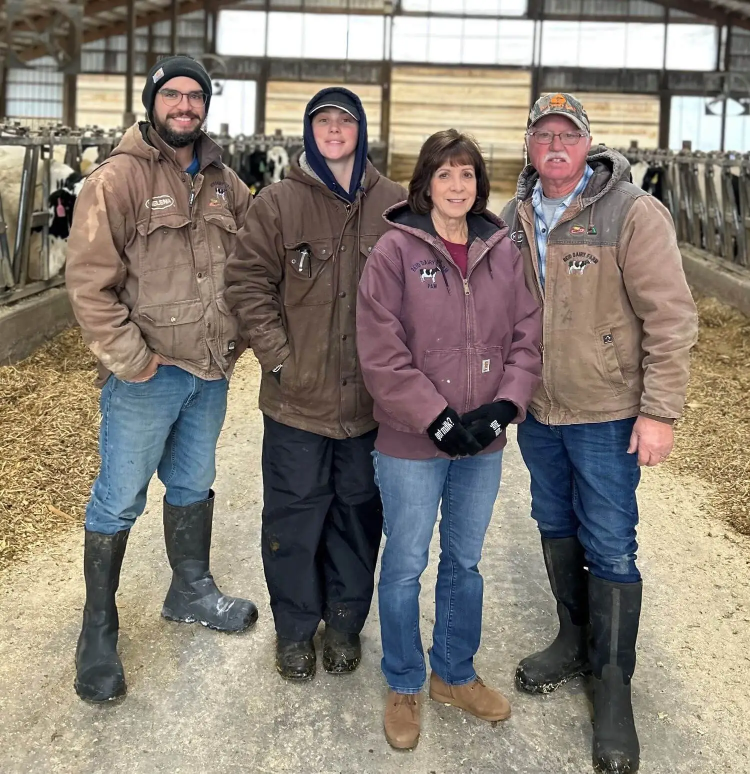 The Reids, a Michigan dairy farm family, posing for a photo in their barn near Lake Huron.