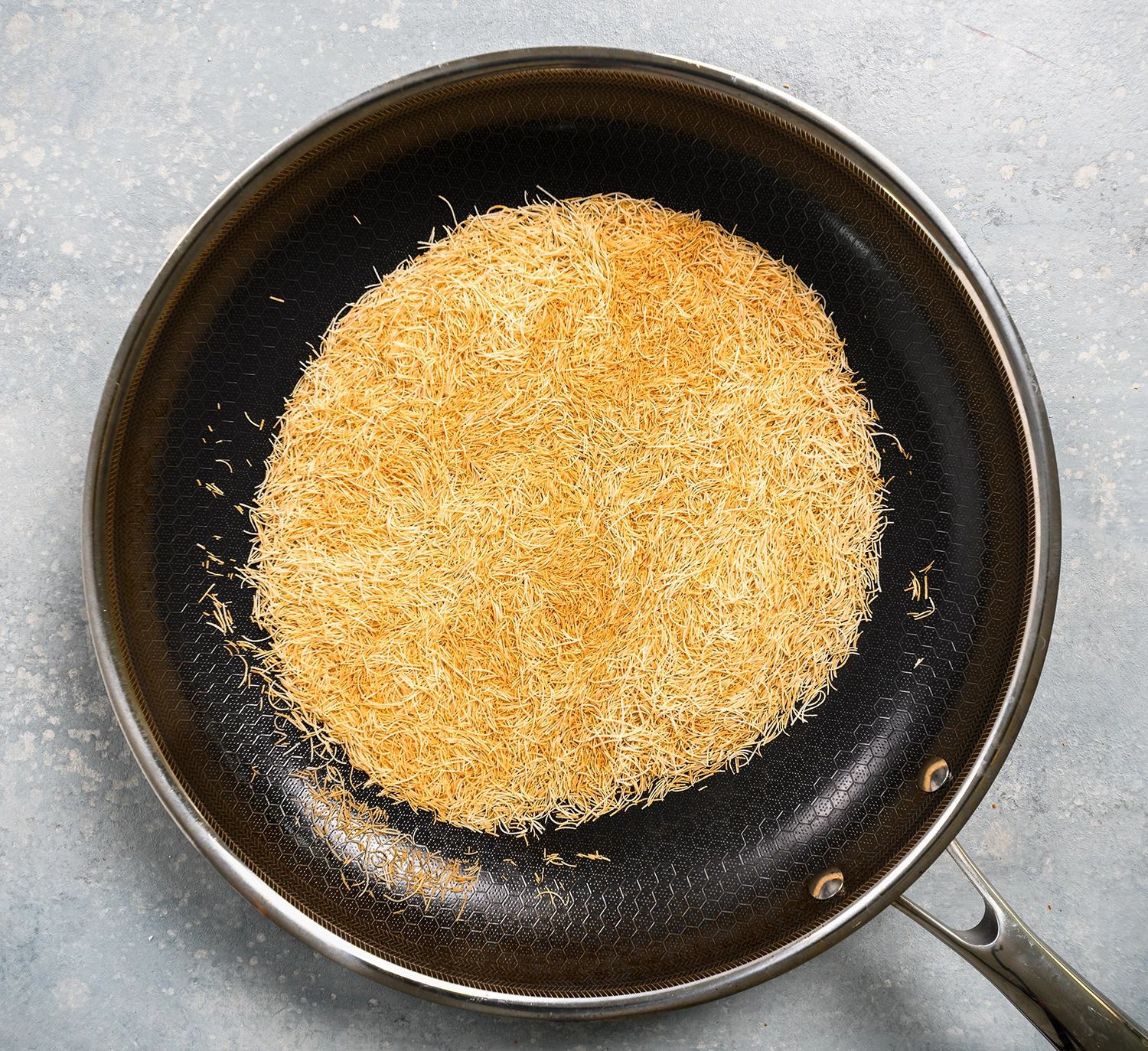 knafeh cut into small threats and toasted in a pan over medium heat.