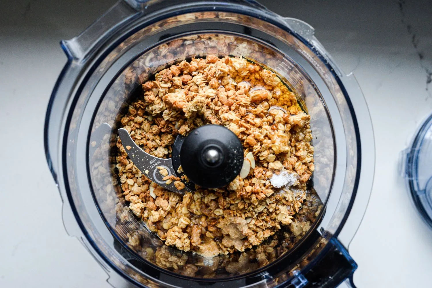 Granola, melted butter, honey, and salt in a food processor.