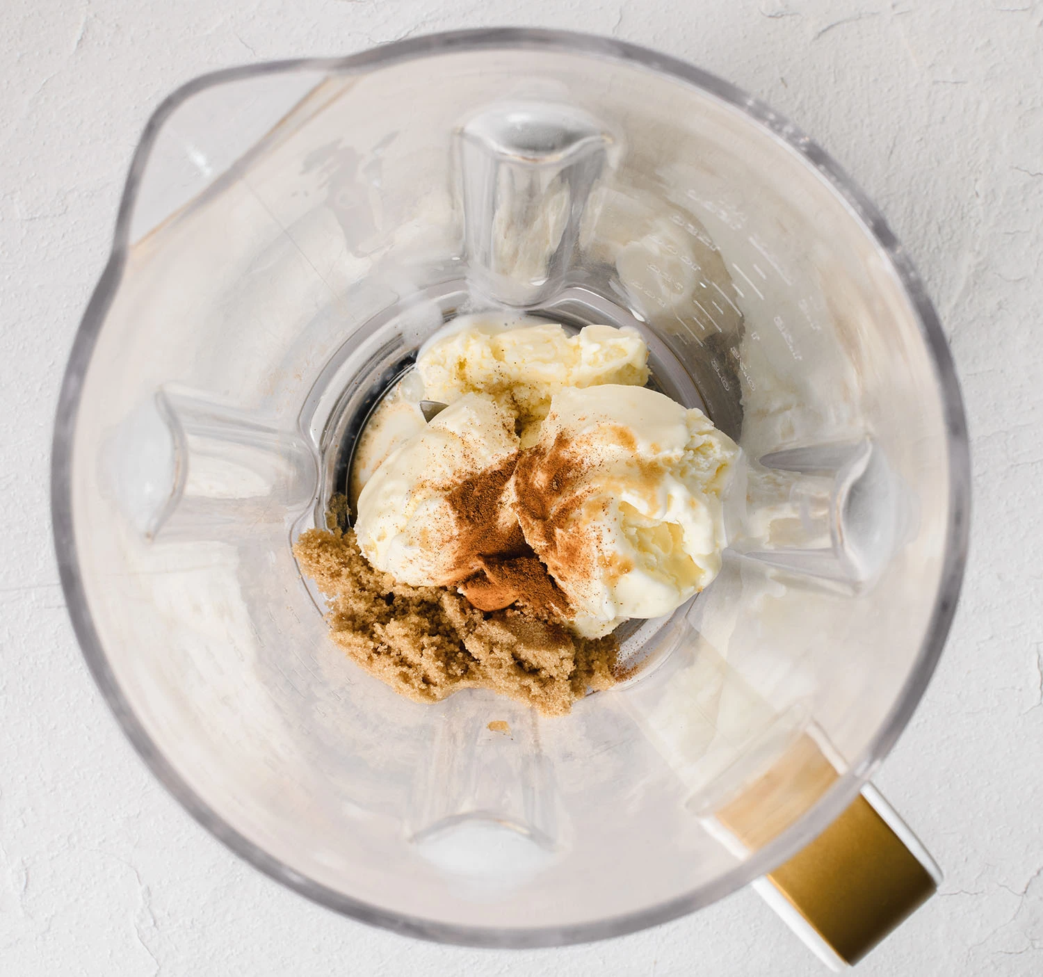 Milk, brown sugar, cinnamon tequila, and ice cream in a blender to make a churro milkshake.