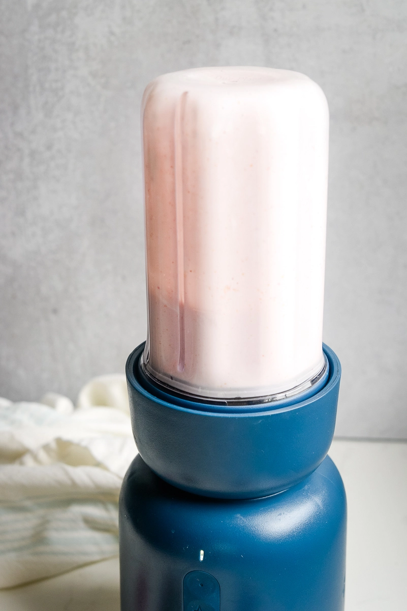 Smooth, blended light pink strawberry cottage cheese mousse mixture.