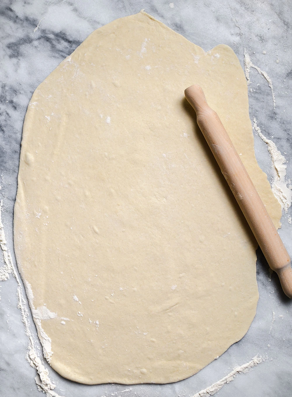 Greek Yogurt Chai Cinnamon Roll dough rolled into a large slab.