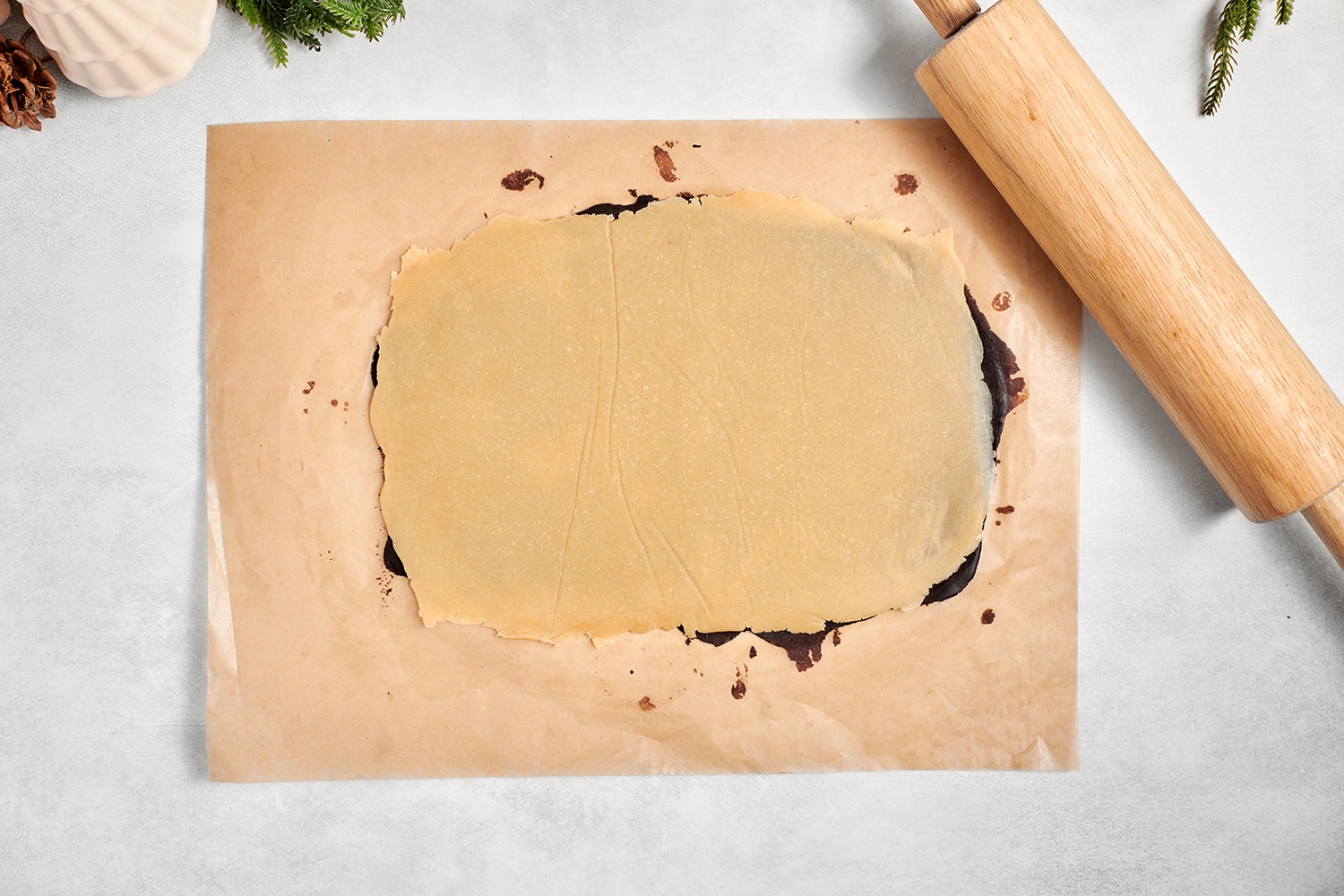 A rectangle of vanilla-flavored cookie dough rolled flat over a rectangle of chocolate-flavored cookie dough