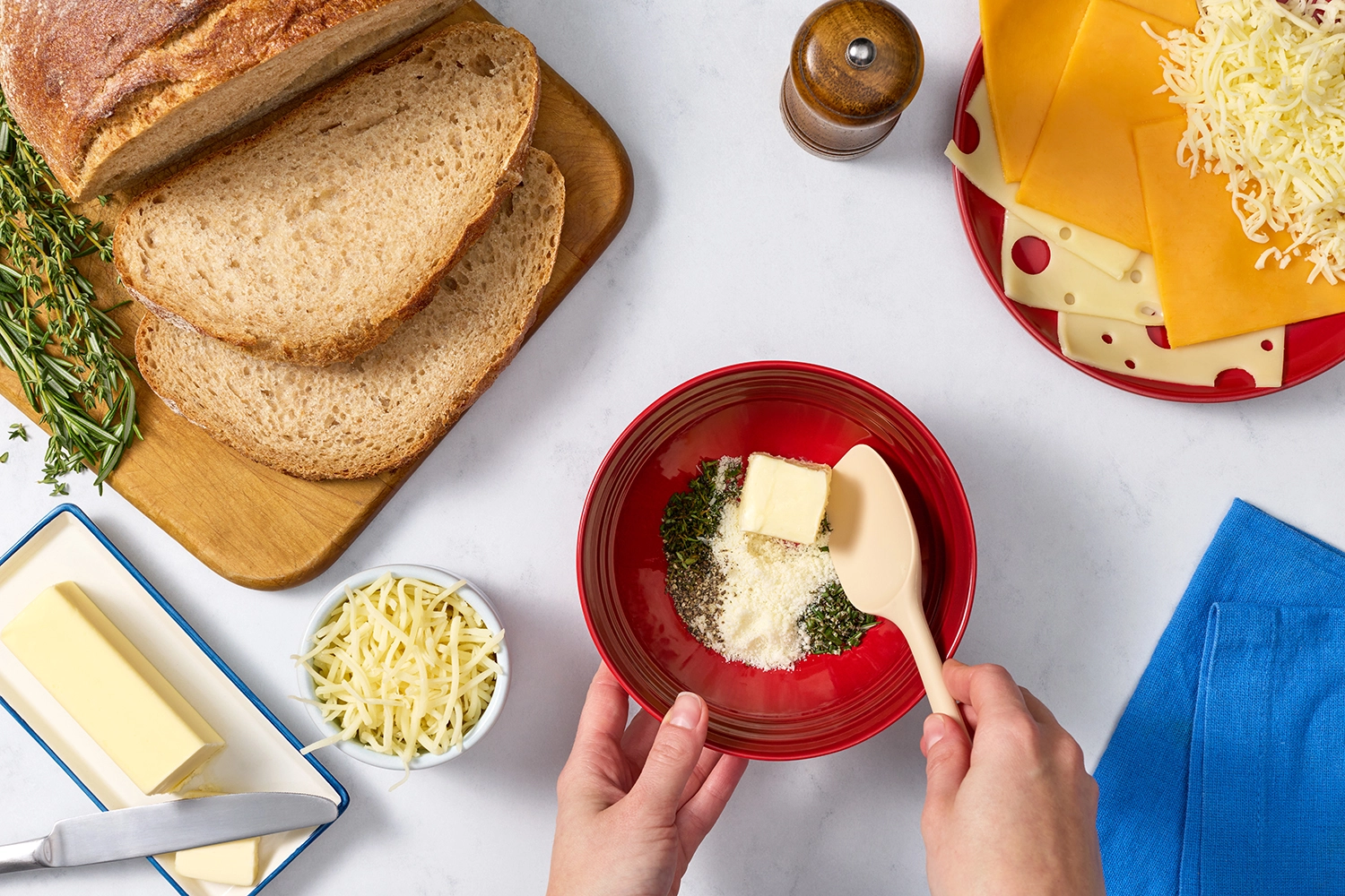 Stirring the butter, Parmesan, and herbs together.