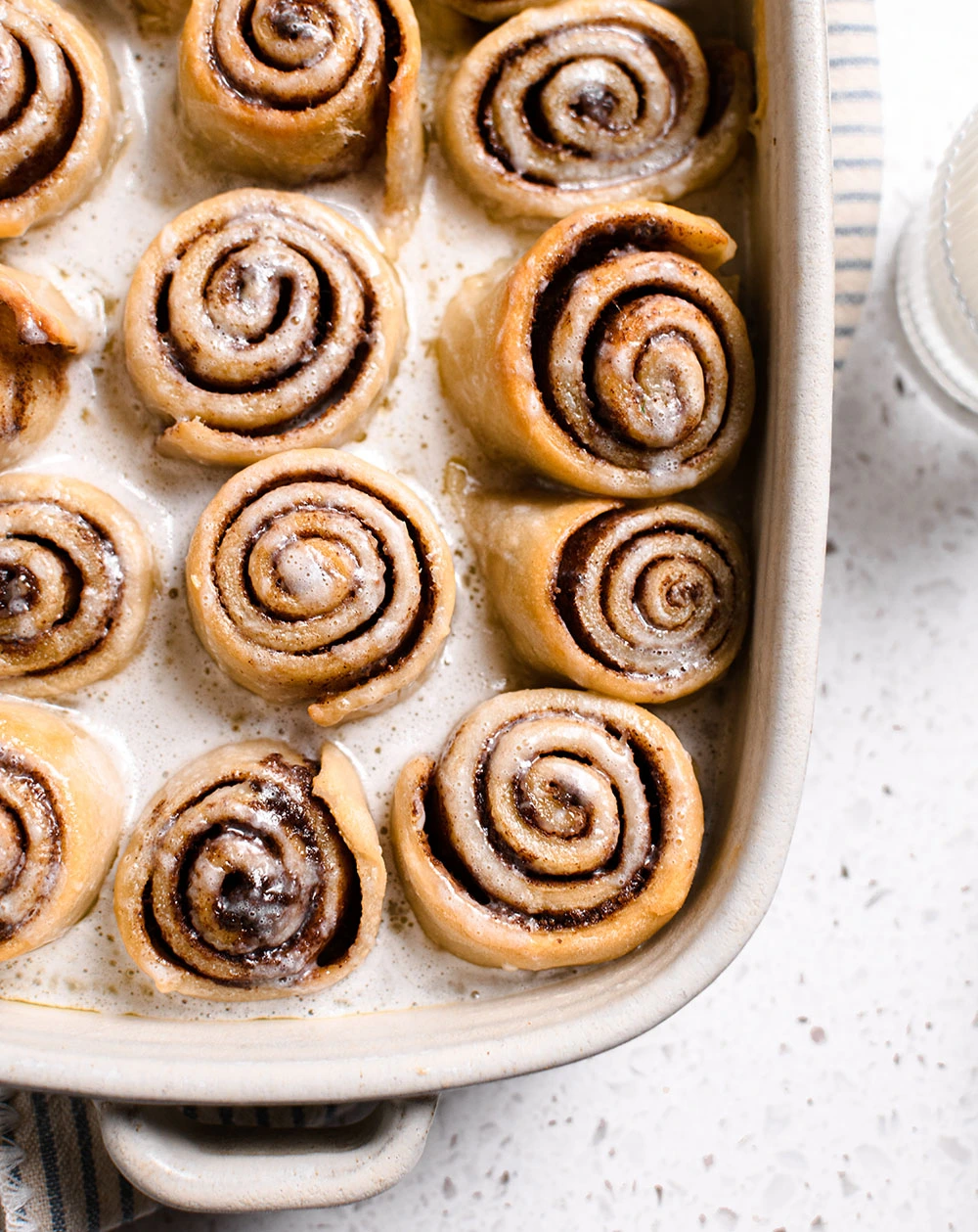 Greek Yogurt Chai Cinnamon Rolls drizzled with icing.