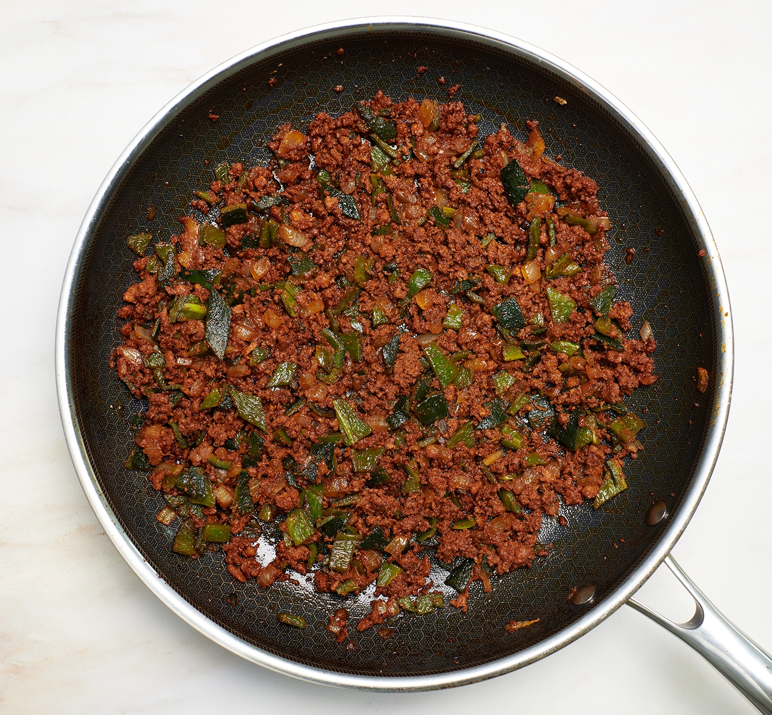 Sautéd onions, chorizo and chopped poblanos in a skillet.