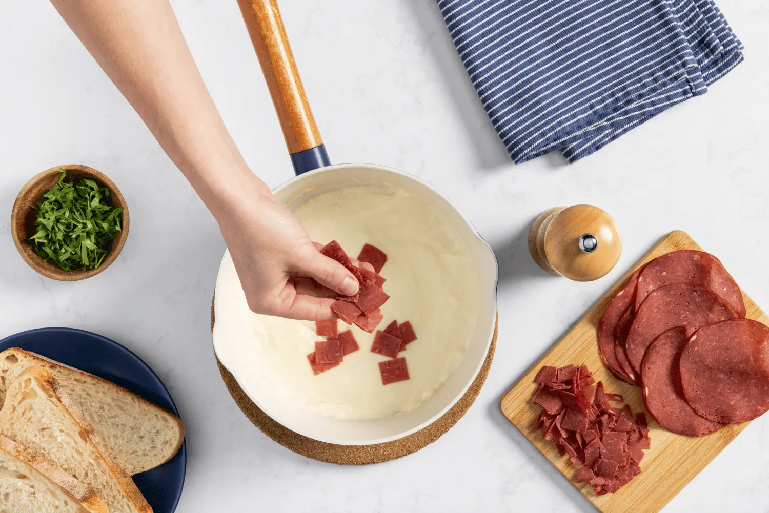 Chipped beef added into small pot with butter, milk, and flour mixture.