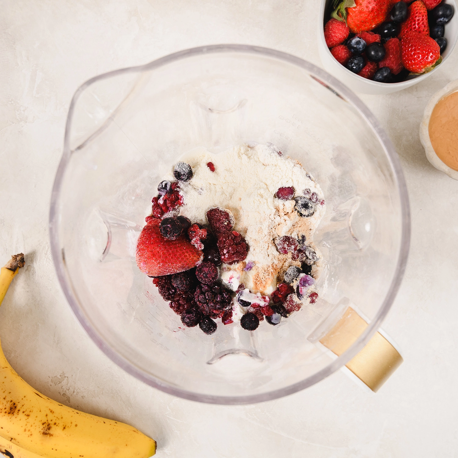 whole milk, Greek yogurt, berries, banana, powdered peanut butter and vanilla protein in a blender.
