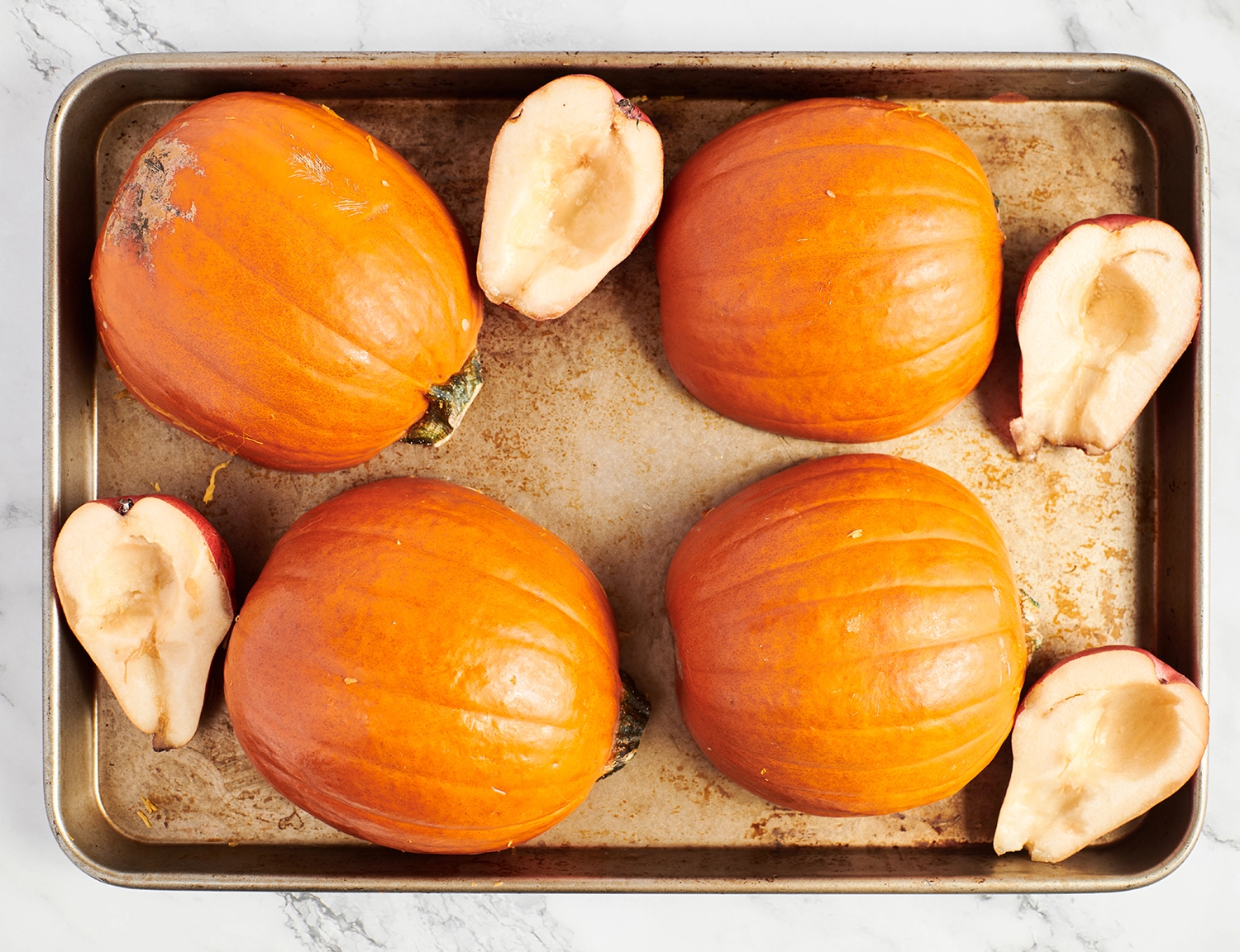 Pumpkins and pears ready to be baked until a fork easily pierces all the way through.